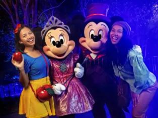 Mickey and Minnie Mouse with guests at Mickey's Not So Scary Halloween Party