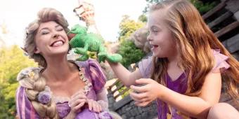 Rapunzel with a child playing with plush toy in the Magic Kingdom Park 