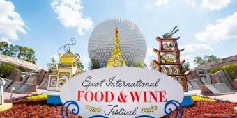 A sign reading "EPCOT International Food and Wine Festival" in front of Spaceship Earth