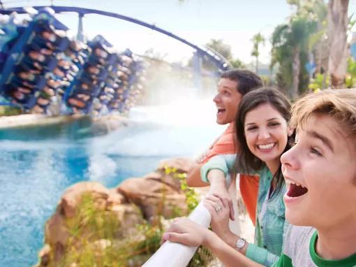 Boy watching guests riding Manta rollercoaster at SeaWorld Orlando