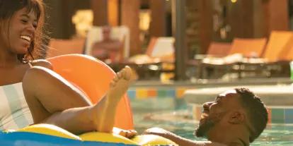 couple in the pool at Universal's Endless Summer Resort, a vibrant and sunny retreat.