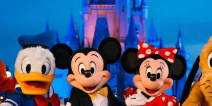 Walt Disney World Resort Goofy, Donald, Mickey, Minnie, and Pluto standing in front of Cinderella Castle at night