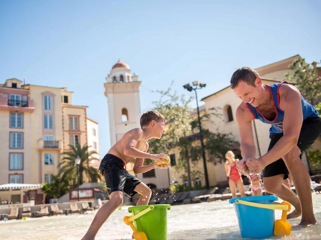 Father and son playing on the beach at Loews Portofino Bay Hotel