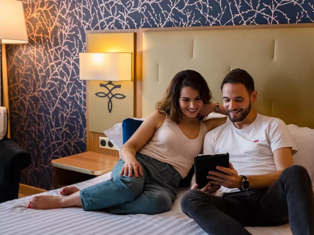 Couple in a standard room at the Dream Castle Hotel Paris