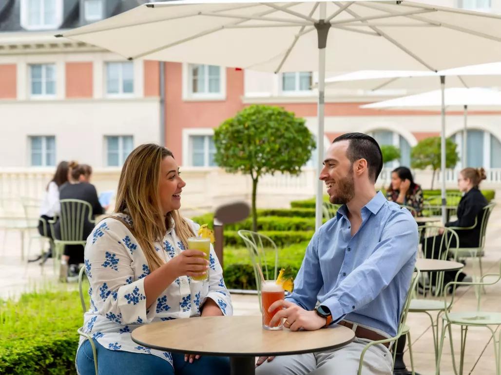 Couple enjoying a drink on the outside terrace at Dreams Castle Hotel Paris