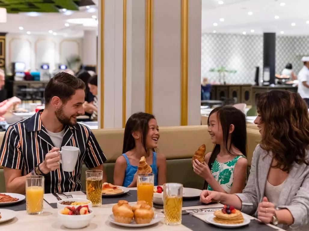 Family eating breakfast at Restaurant Le Bosquet at Dreams Castle Hotel Paris