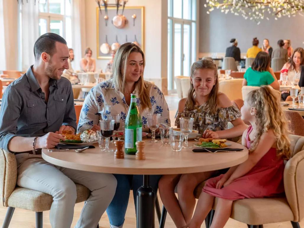 Family enjoying refreshments in the Dream Castle Hotel Paris lounge area