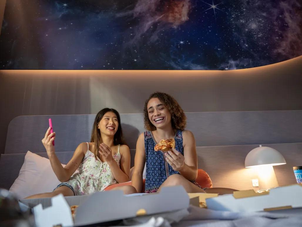 Guests eating pizza in standard room at Universal Stella Nova Resort