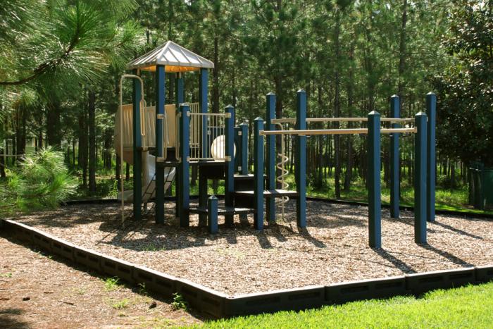 Children's playground with slide and climbing bars at Highlands Reserve