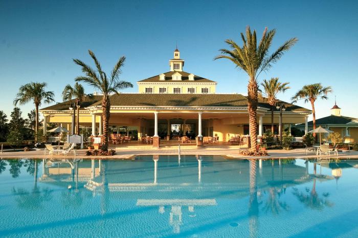 Grand clubhouse with cupola reflected in the pool at sunset at Reunion Resort