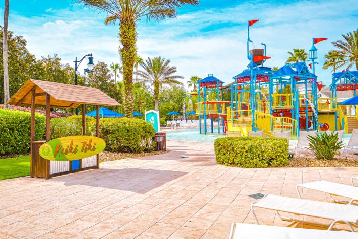 Entrance sign to the Kiki Tiki water play area with colorful slides at Reunion Resort