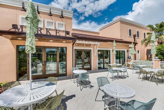 Market and coffee shop exterior with outdoor patio seating at Solara Resort