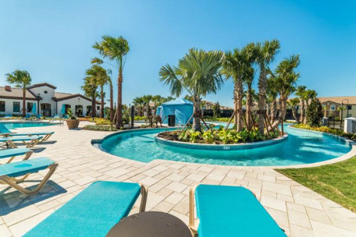 Lazy river winding around a palm tree island at Windsor at Westside