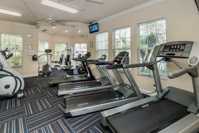 Gym room with treadmills and steppers