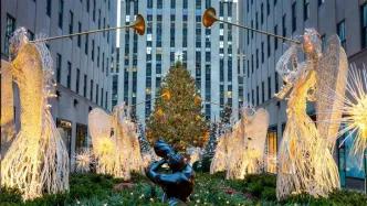 Glowing angel decorations in front of the Rockefeller Center Christmas Tree
