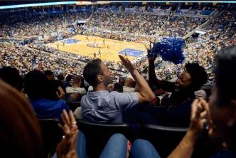 Two friends high-fiving while watching an Orlando Magic game