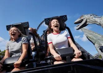 Guests laughing and screaming with excitement on the Jurassic World VelociCoaster at Universal Orlando Resort, one of the top attractions in Orlando.