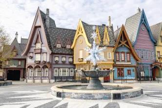Arendelle-style buildings surround a crystalline snowflake fountain at Disneyland® Paris