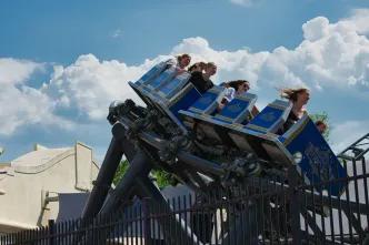 Families riding a thrilling roller coaster at a theme park