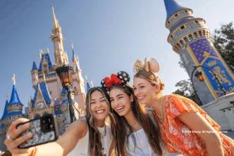 Three guests taking a selfie outside Cinderella Castle