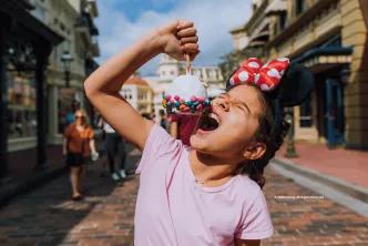 Guest on Main Street, U.S.A. eating a snack