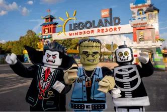 Three costumed Lego Halloween characters standing in front of the Legoland Windsor Resort entrance