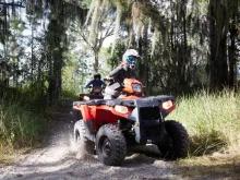 Orlando ATV Driving Experience Two people riding red ATV's in Orlando