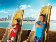 Two men at the start of Posidons Revenge water slide at Aquaventure Dubai