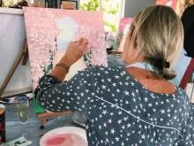 woman-painting-orchard