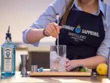 person-making-gin-cocktail