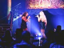 two-people-singing-on-stage