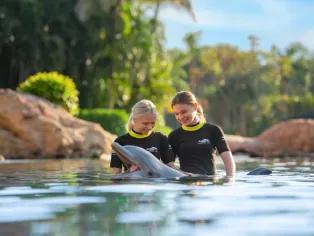 Girls interacting with a dolphin at Discovery Cove Orlando