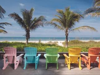 Anna Maria Island A row of different coloured beach chairs looking out onto the beach