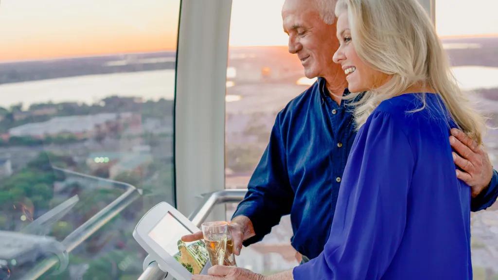 Couple enjoying champagne on the Icon Orlando Wheel