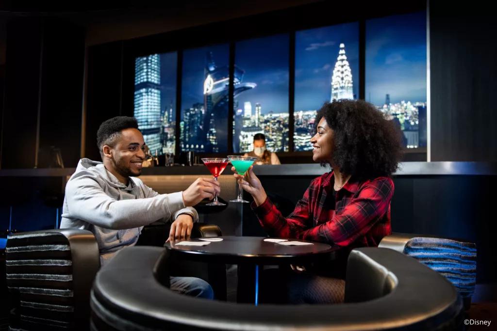 Skyline Bar A man and a woman holding up cocktails at the Skyline Bar