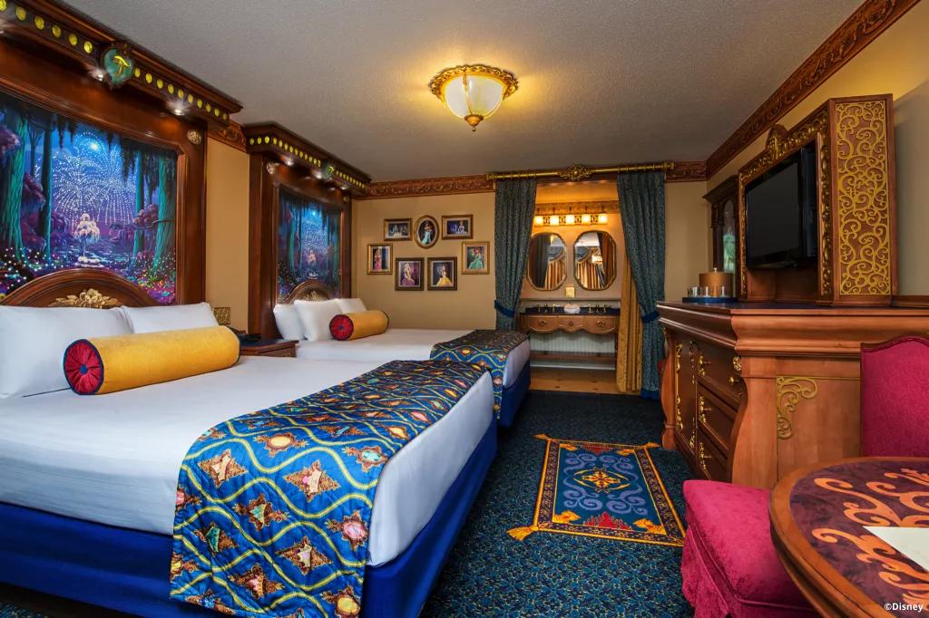 The Royal Guest Rooms at Port Orleans Resort - Riverside A royal room at Port Orleans Resort, with two double beds and portraits of princesses on the wall