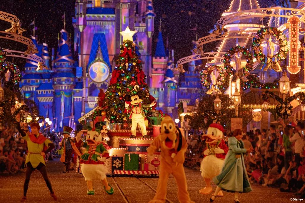 Mickey's Once Upon a Christmastime Parade Pluto, Peter Pan, Wendy and other Disney characters walking down Main Street in the Christmas Parade