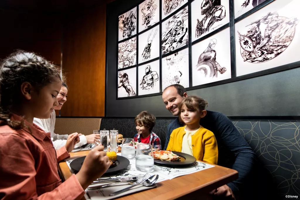 Downtown Restaurant at Hotel New York - Art of Marvel A family eating dinner at the Downtown Restaurant in Disneyland Paris