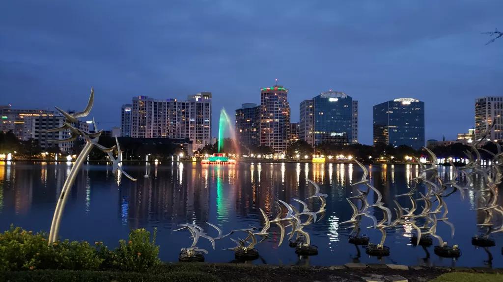 Lake Eola Lake Eola at night with skyscrapers in the background and bird sculptures in the foreground