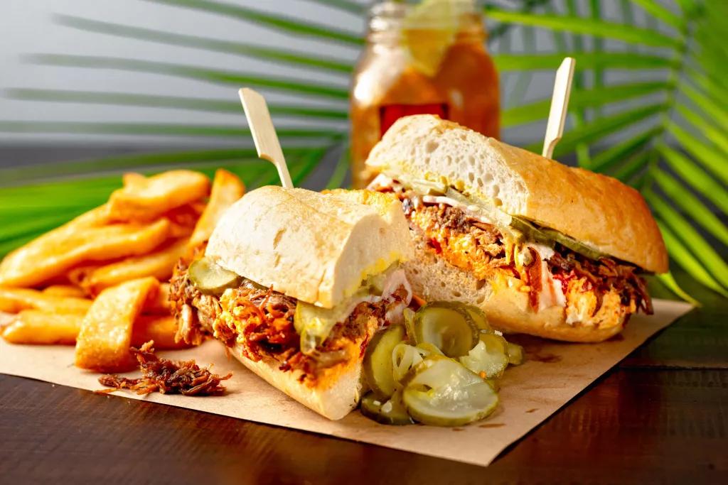 Ole Red Brisket Sandwich A brisket sandwich served with fries and pickles