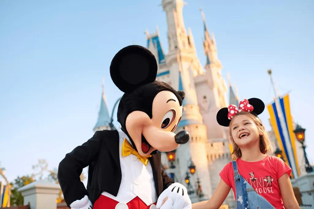 Meet Mickey Mouse at Magic Kingdom Mickey Mouse meeting a girl in front of Cinderella Castle in Magic Kingdom
