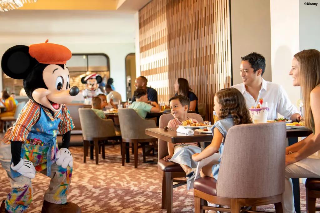 Character Dining at Topolino's Terrace: Flavours of the Riviera Mickey Mouse meeting guests dressed as a French painter