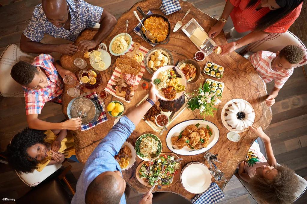 Dining at Walt Disney World Resort A family dining at a wooden table full of food