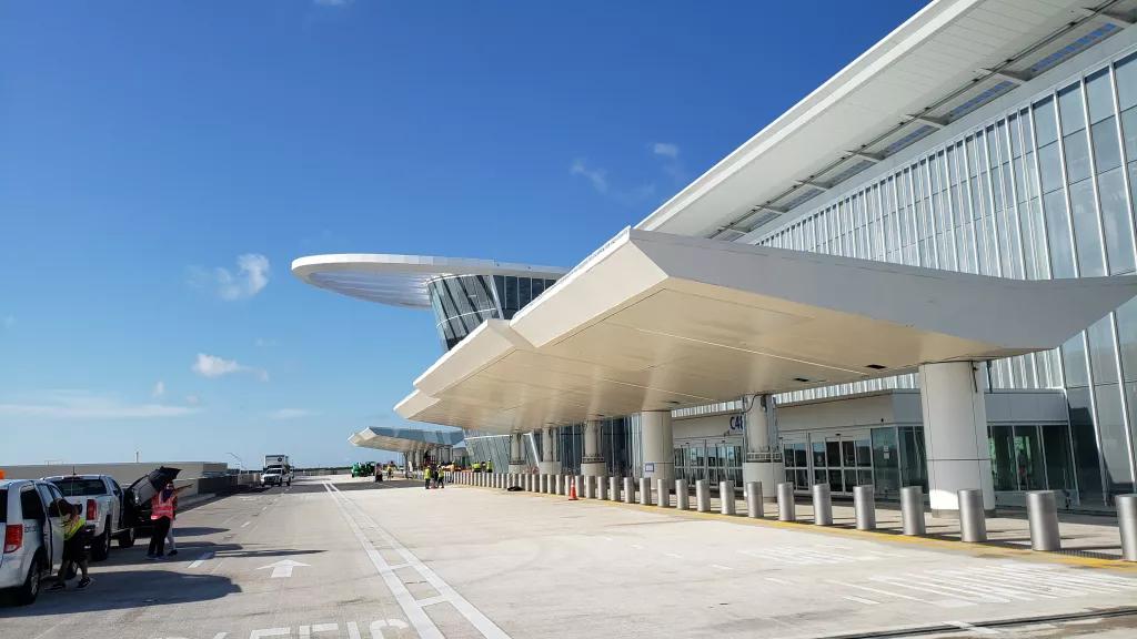 MCO Terminal C The outside of Terminal C at MCO with a road in front for taxis and drop off