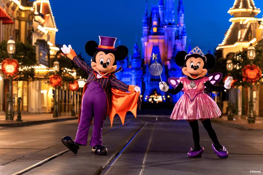 Mickey's Not-So-Scary Halloween Party Mickey and Minnie in Halloween costumes in front of Cinderella Castle