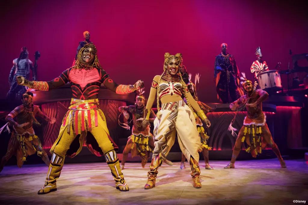 The Lion King: Rhythms of the Pride Lands Performers dressed in African inspired outfits in The Lion King: Rhythms of the Pride Lands