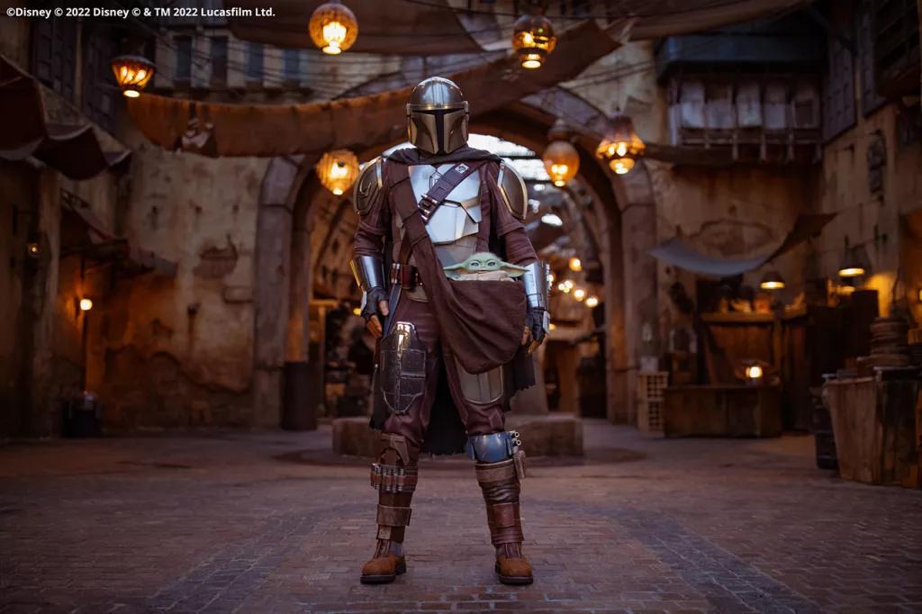 The Mandalorian in Star Wars: Galaxy's Edge The Mandalorian wearing full armour standing in Star Wars: Galaxy's Edge