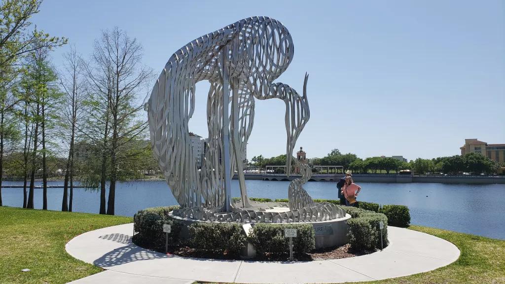 Cranes Roost Sculpture A metal sculpture of a crane in front of a large lake