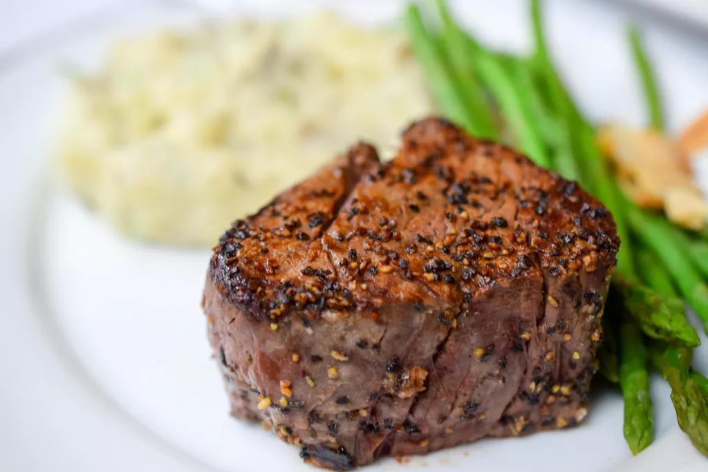 Filet at Christner's A cooked filet steak on a plate with mashed potatoes and green beans