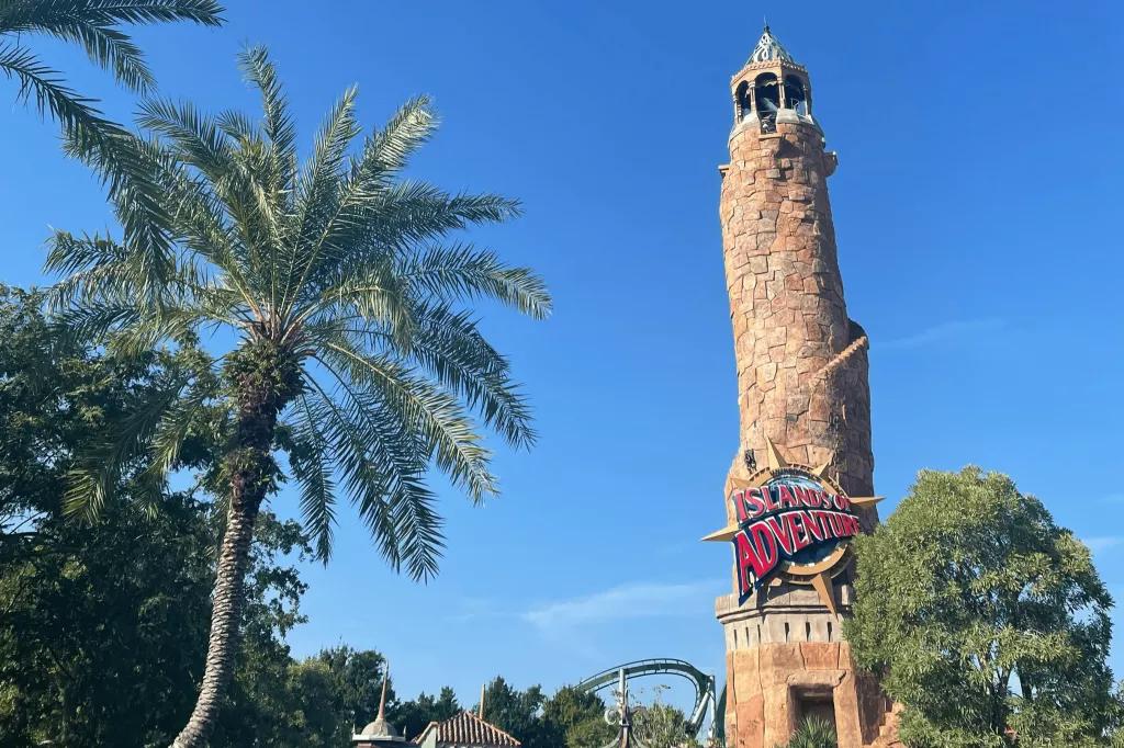 Islands of Adventure at Universal Orlando Resort The entrance to Islands of Adventure in front of palm trees and a blue sky